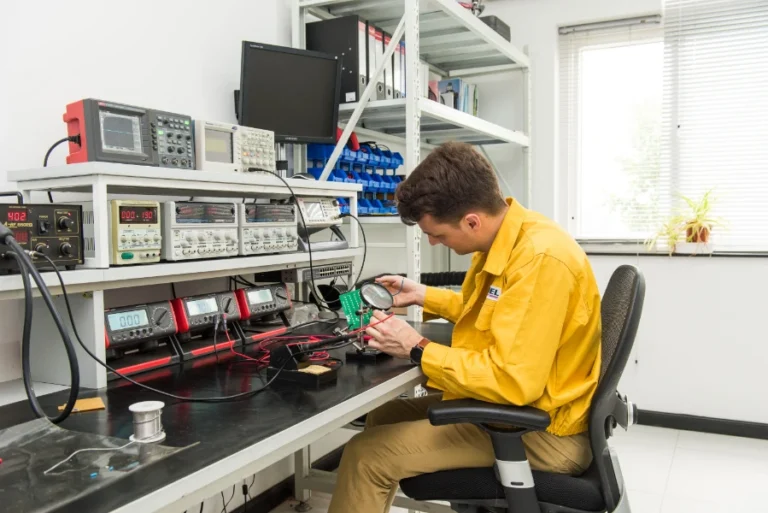 electrical engineer testing electronic circuit board in rd laboratory with test equipment