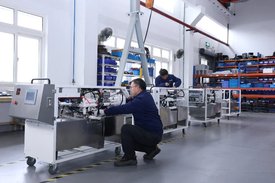 industrial equipment assembly production line factory floor workers testing manufacturing machinery
